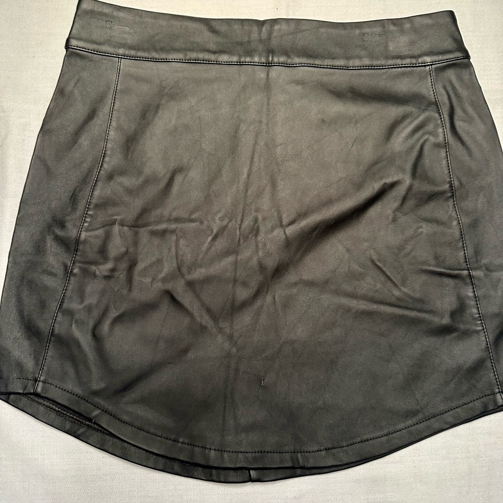 Charlotte Russe. Black pleather skirt with zipper back and asymmetrical hem Sz M